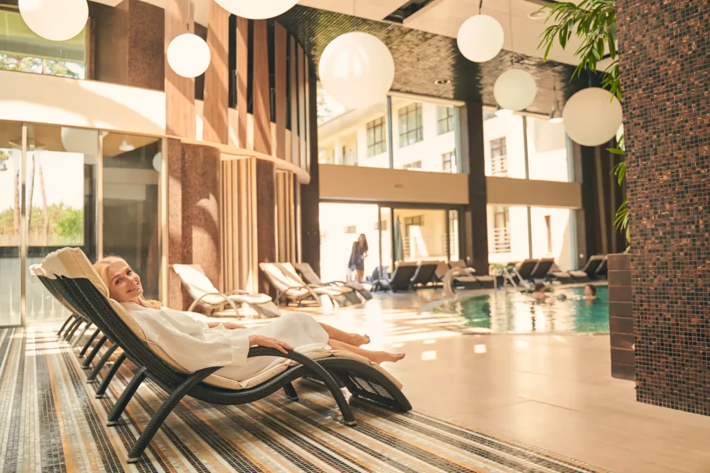 happy-adult-woman-lying-on-sun-bed-at-luxury-spa-h-2023-11-27-05-36-33-utc_result.webp